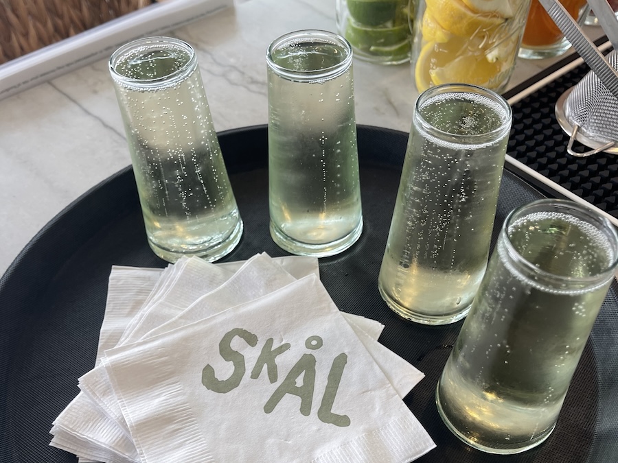 Champagne glasses on a tray arranged around Skal-branded napkins